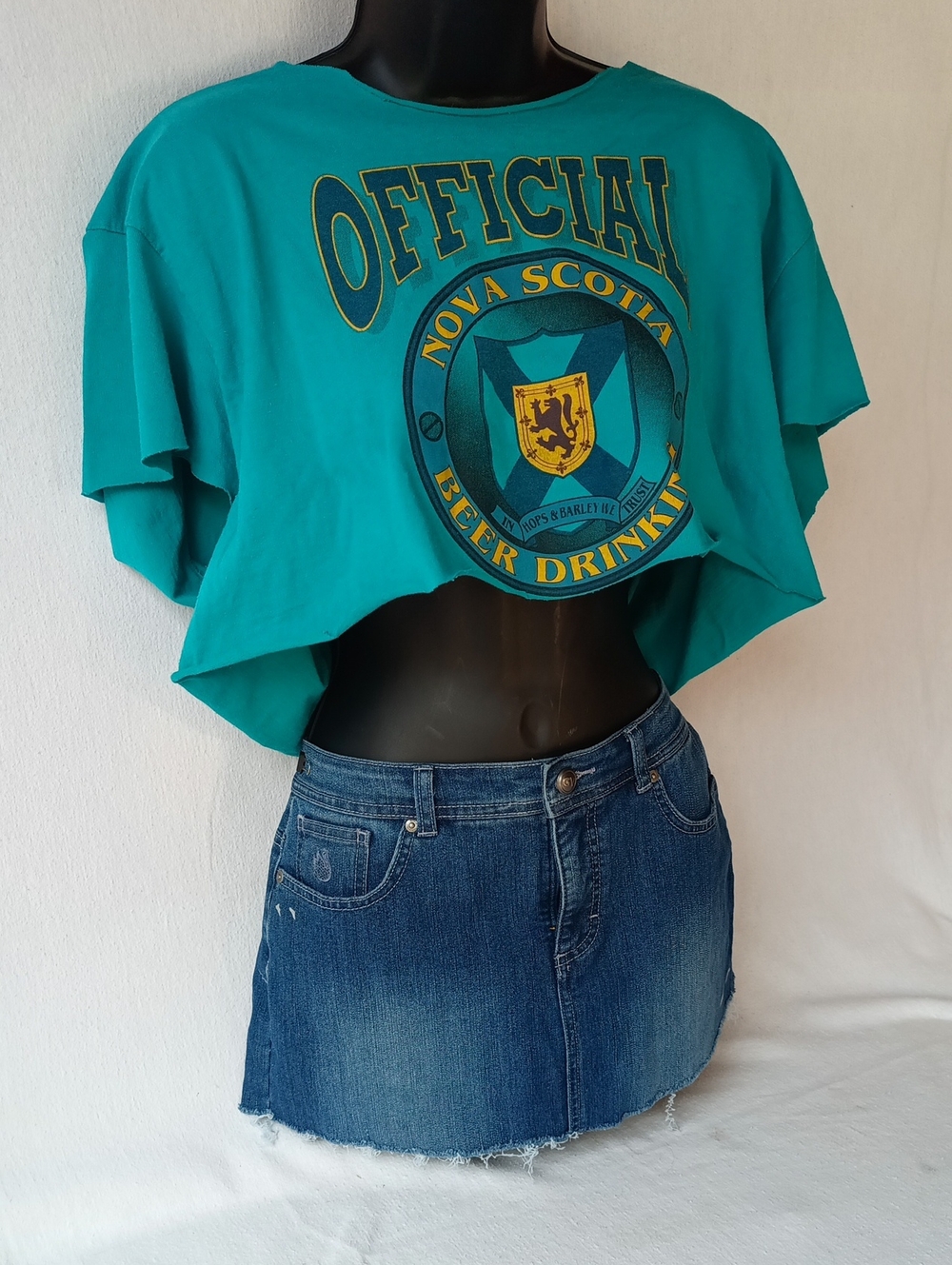 Teal Crop Top With Large Graphics Front And Back.    -Women’s Short Sleeve Tee